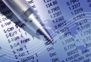 World outline map overlaid onto finacial newspaper and pen.