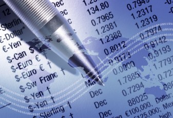 World outline map overlaid onto finacial newspaper and pen.